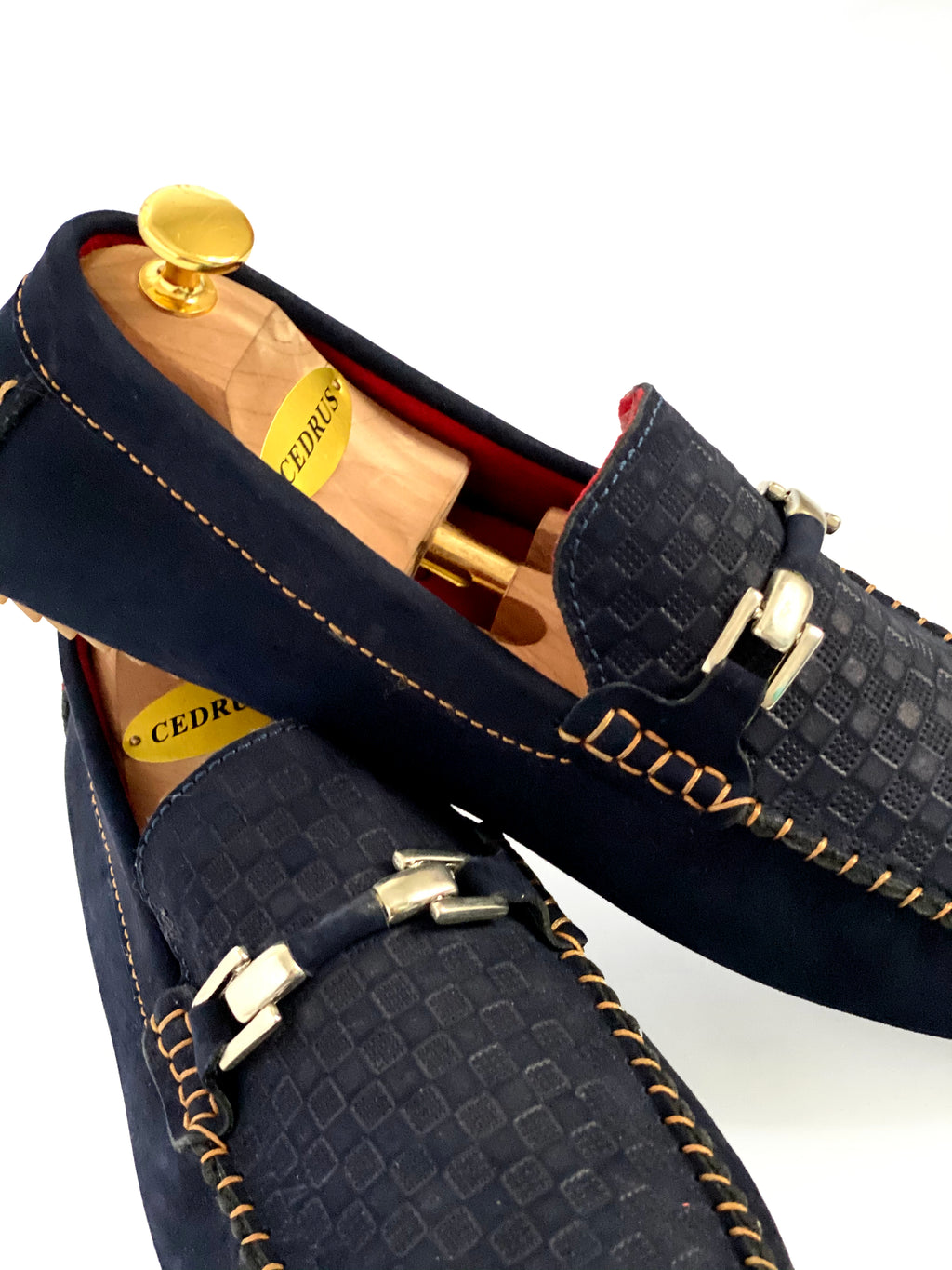 The Classic Navy Blue Nubuck Moccasin Leather Slipper Shoe With Sheepskin Lining, Rubber Soles, Leather Shoelaces, Whipstitch Details At Toe, Classic Woven Styling, And Moc-toe moccasin with saddle bit. The Moccasin is made entirely out of the softest, most comfortable, breathable and durable leather. Jebranco New York NYC. Men Moccasin Slipper Shoe, Man Moccasin Slipper Shoe, Boat Shoe, Leather Shoe, NYC Shoe Store, NYC Online Shoe Store, Navy Slippers, Slipper Shoe. 